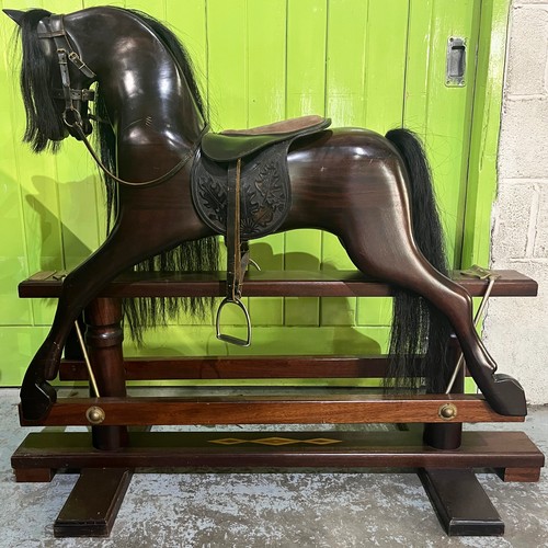 323 - Rocking horse on swing stand complete with tack and accessories, plaque on front reading 