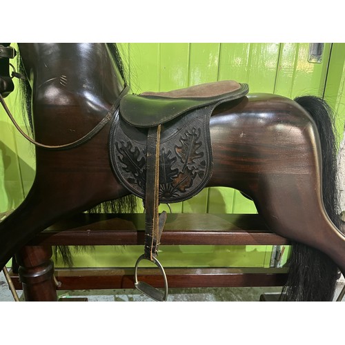 323 - Rocking horse on swing stand complete with tack and accessories, plaque on front reading 