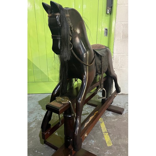 323 - Rocking horse on swing stand complete with tack and accessories, plaque on front reading 