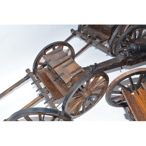 140 - Two large cannon models in metal and wood with ammunition tenders and a pair of spare wheels. Approx... 