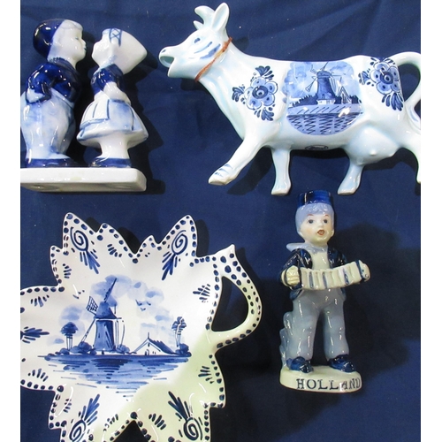 654 - Large collection of Delft blue and white pottery including jugs, vases, milk jugs, windmills and fig... 