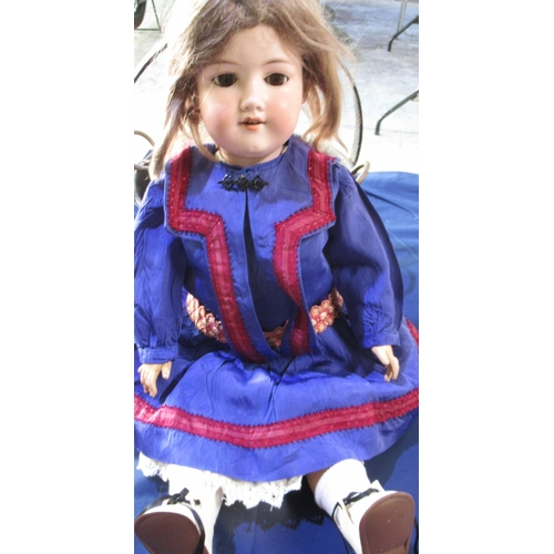 622 - Armand Marseille doll stamped 390 DRGM 84G/1 A61/2 M, wearing brown wig, blue dress, white socks and... 