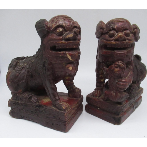 259 - Pair of Chinese carved wooden Dog of Foe candlesticks, on rectangular base, later painted with trace... 