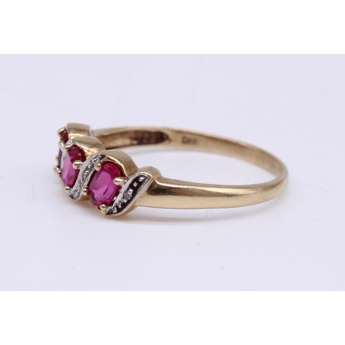 959A - 9ct gold three stone ruby and diamond crossover ring, size T, 2.0 g