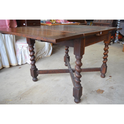 228 - 1930's oak draw leaf dining table on barley twist supports with cross stretcher, an oak stool and a ... 