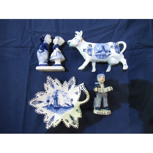 654 - Large collection of Delft blue and white pottery including jugs, vases, milk jugs, windmills and fig... 