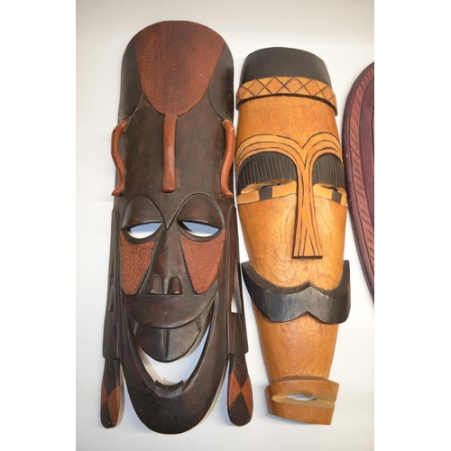 145 - Five modern African tribal style wooden face masks, various sizes, the largest L64cm