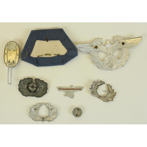 57 - Selection of German WWII Third Reich metal peak cap badges to include Luftwaffe etc.