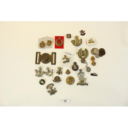 87 - Selection of British military cap badges, emblems, belt buckles,  mainly WWI through WWII, highlight... 