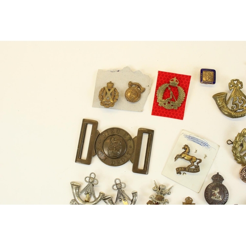 87 - Selection of British military cap badges, emblems, belt buckles,  mainly WWI through WWII, highlight... 