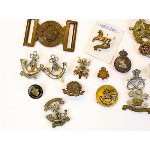 87 - Selection of British military cap badges, emblems, belt buckles,  mainly WWI through WWII, highlight... 