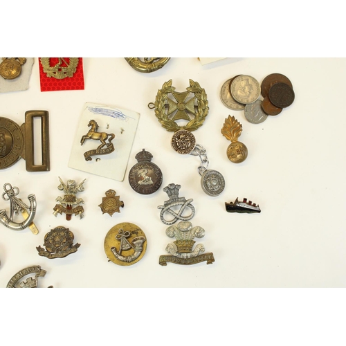 87 - Selection of British military cap badges, emblems, belt buckles,  mainly WWI through WWII, highlight... 