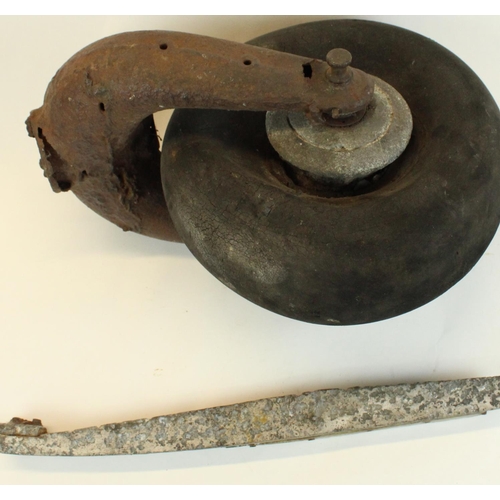 178 - WWII era tail wheel from an unidentified aircraft together with a piece of fuselage