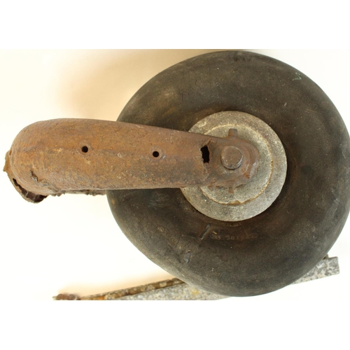 178 - WWII era tail wheel from an unidentified aircraft together with a piece of fuselage