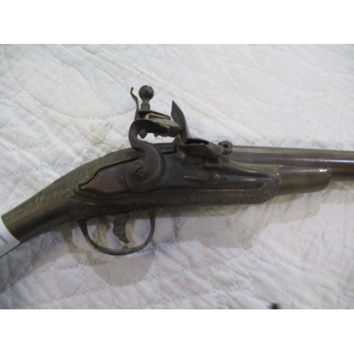 890 - C19th Arabic flintlock pistol with ornate carving to lock, handle and pommel, overall approx L19