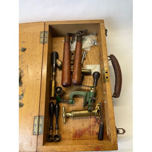 963 - Quality wooden box with leather handles, containing collection of shooting apparel, including two po... 