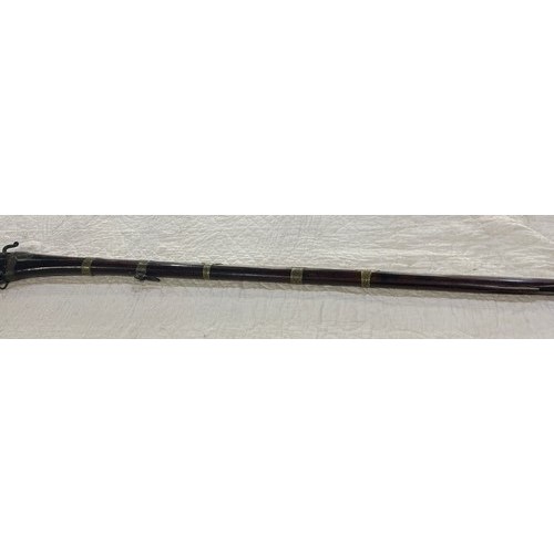 877 - Indo-Persian antique musket, with ornate brass banding, overall approx L158cm/5ft 2