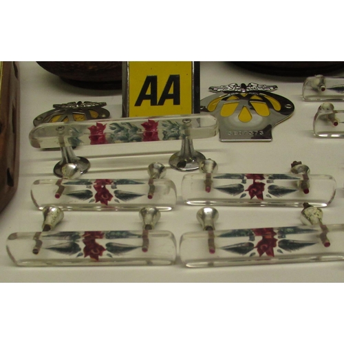 557 - C20th glass door handles with encased ceramic hand-painted flowers (9), 3 AA car badges, a loom shut... 