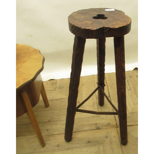 170 - C20th rustic carved pine stool on three splay legs joined by iron under stretcher and a 1950s walnut... 