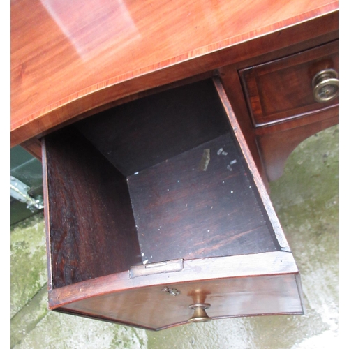 353 - C20th serpentine mahogany kneehole sideboard with crossbanded top on square tapering legs with spade... 