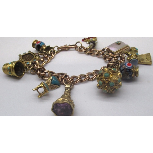 1253 - 9ct yellow gold bracelet, stamped 9ct, with ten attached Victorian and later yellow metal charms inc... 