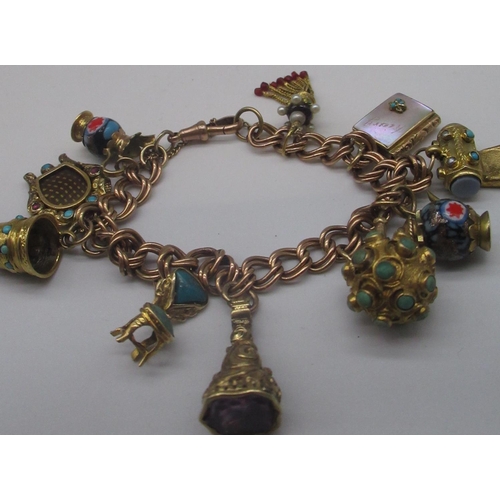 1253 - 9ct yellow gold bracelet, stamped 9ct, with ten attached Victorian and later yellow metal charms inc... 