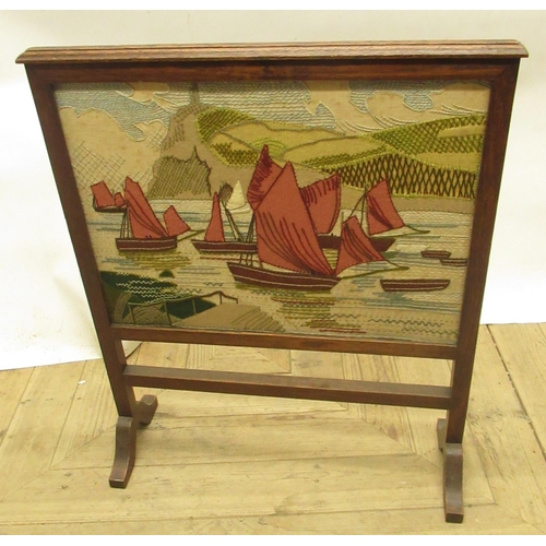 451 - C20th oak framed fire screen with inset needle work panel of fishing vessels