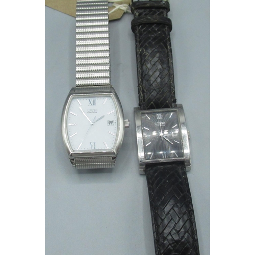 605 - Citizen Eco-Drive wristwatch with date, chrome plated rectangular case, on leather strap and another... 