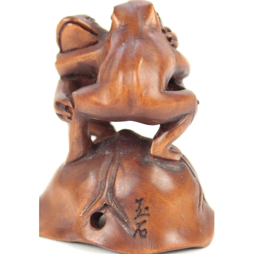 1359 - Japanese Meiji period boxwood Netsuke figure of two frogs, H4.5cm and a fish Netsuke