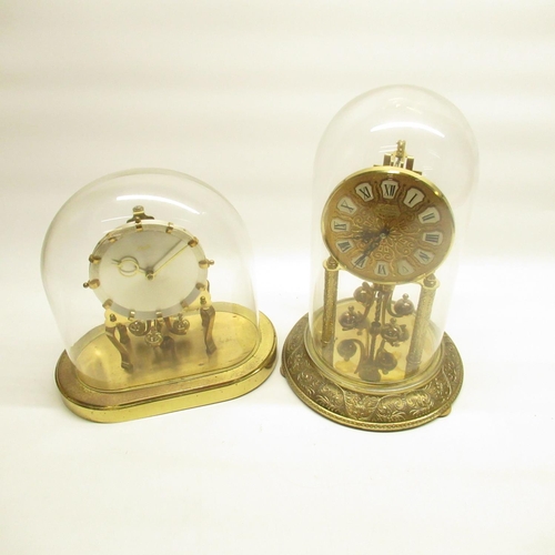 669 - Two Kundo brass suspension clocks under glass domes, respective heights are 31cm and 24cm