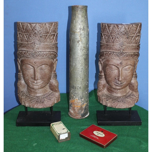 24 - Pair of South East Asian Buddha type sculptures, a tall shell case, a Craven-A cigarette tin and a F... 