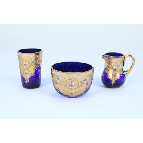 1336 - Early C20th Bohemian blue glass and gilt enamel miniature jug, bowl and beaker set in the manner of ... 