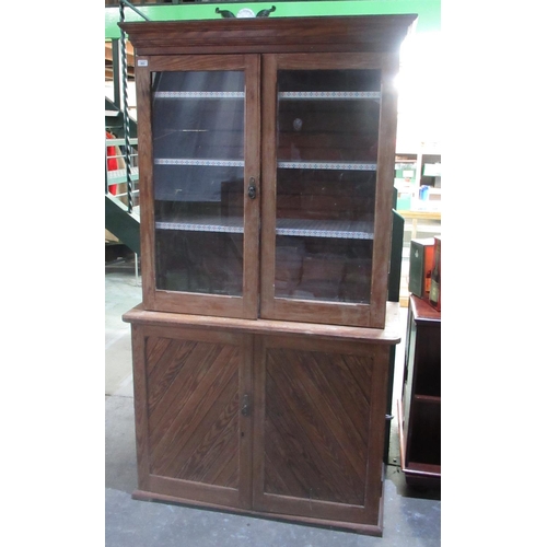 283 - Victorian pitch pine side cabinet with two glass doors and three shelves above two panel doors on sk... 