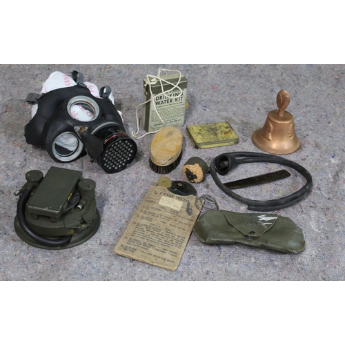 806 - WWII military related items, including gas mask, water purifier, tin containing drinking water kit, ... 