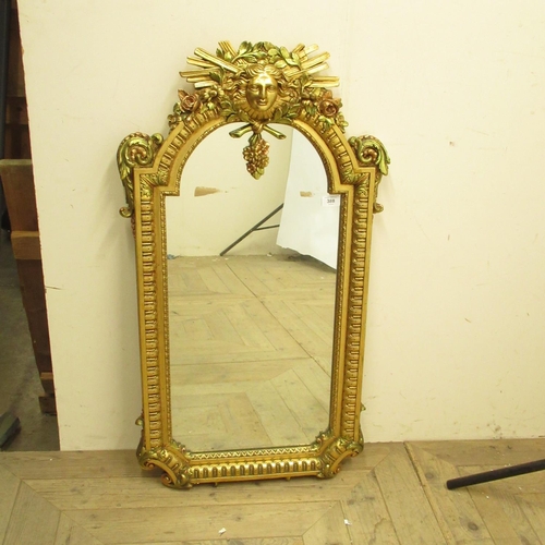 388 - C20th arched top wall mirror, beaded border with mask cresting and , W51cm H97cm