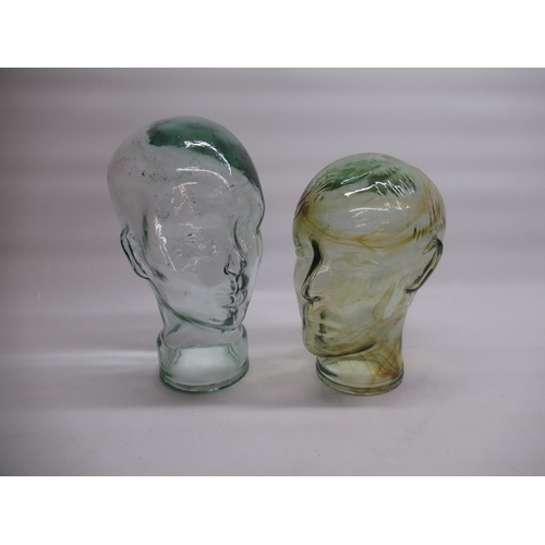 1384 - Two moulded glass phrenology type heads, H26cm and H30cm (2)