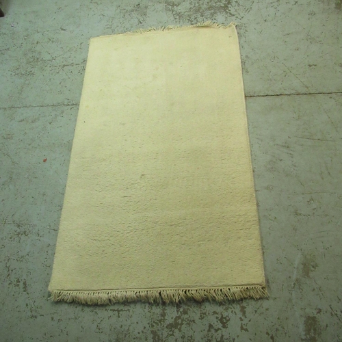 323 - Gooch Sahara mustard 100% hand woven Indian rug, 180cm x 120cm, and 2 Indian ivory coloured hand kno... 