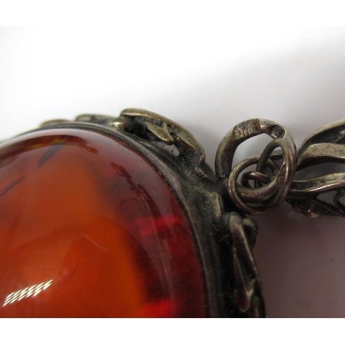 1268 - Sterling silver pendant set with amber, stamped 925, on white metal chain with leaf and fruit decora... 