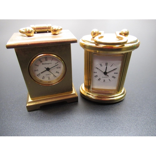 96 - Swiza 8 day travel alarm clock in red leather clam shell case, running, and two miniature brass case... 