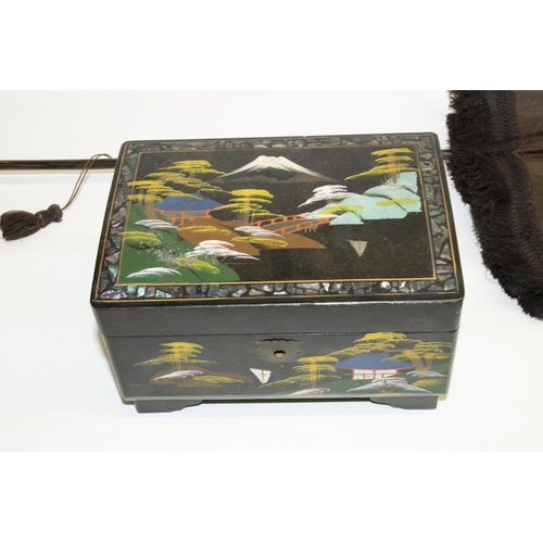 332 - Japanese lacquered musical jewellery box with fitted interior, lid decorated with mother of pearl, L... 