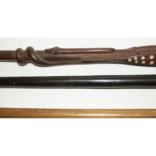 337 - Two Solomon Islands carved wood canes with inlaid pearl decoration, both L93cm, and two other canes ... 