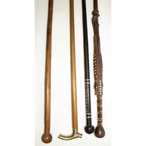 337 - Two Solomon Islands carved wood canes with inlaid pearl decoration, both L93cm, and two other canes ... 