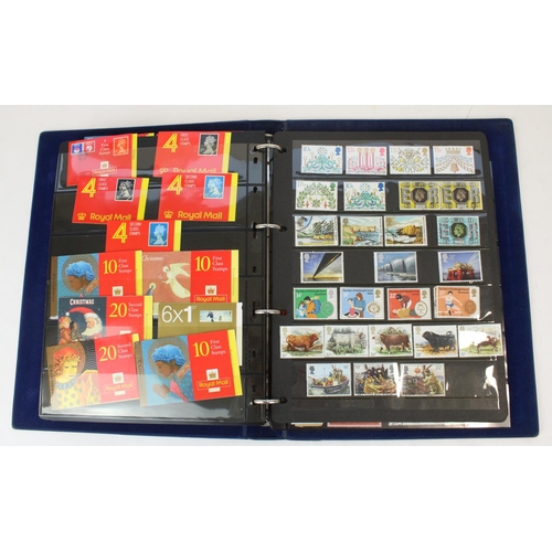 124 - Two stamp albums of GB and world defins. and commems, mint and used together with a small album of w... 