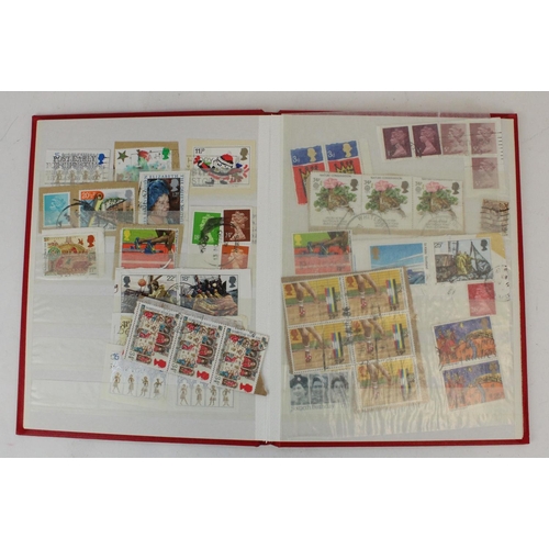 124 - Two stamp albums of GB and world defins. and commems, mint and used together with a small album of w... 