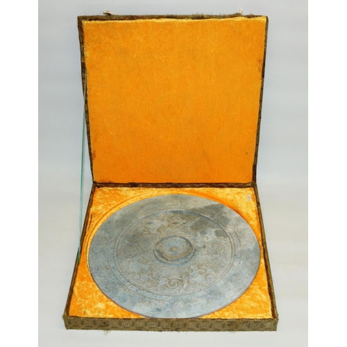 533 - C20th Chinese or Southeast Asian archaic style carved stone disc, in yellow velvet lined presentatio... 