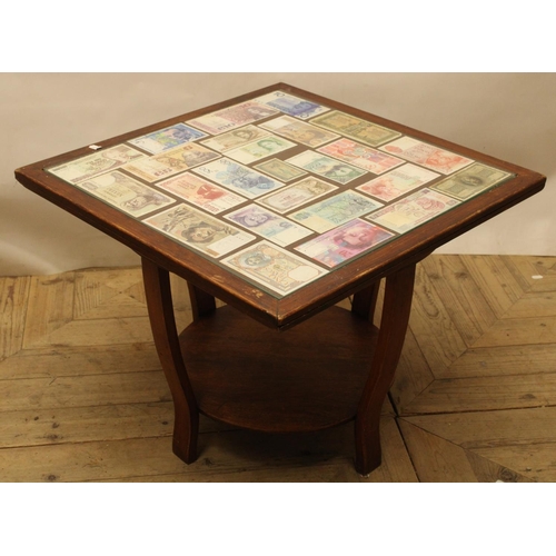 725 - Square topped coffee table inset with collection of world bank notes with glazed top, H48cm