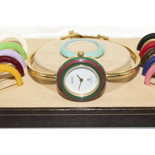 67 - 1990's Gucci quartz wristwatch, on matching bracelet with multi coloured interchangeable bezels, sna... 