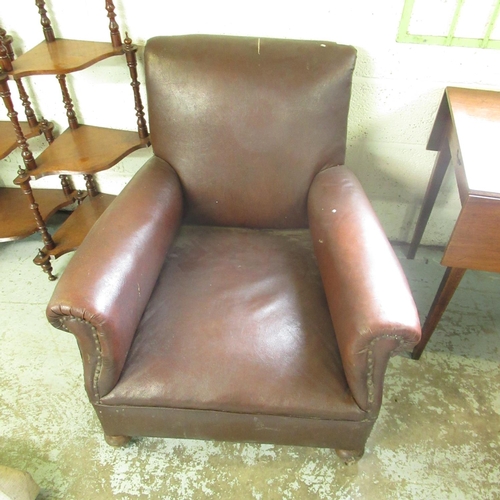 717 - 1930's club armchair, upholstered in brown leatherette on squat bun feet with casters, W84cm D82cm H... 