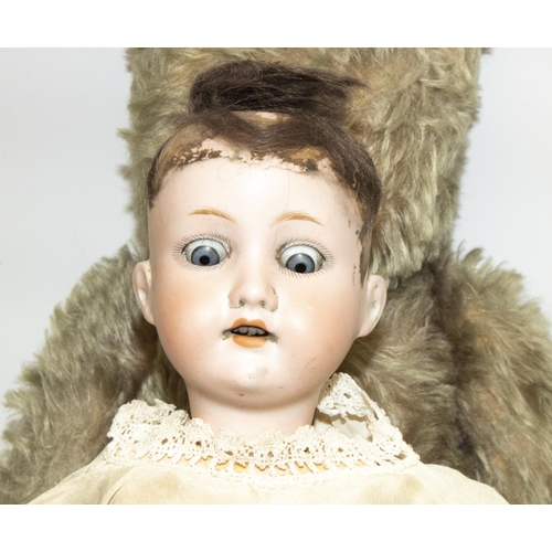 214 - Armand Marseille early C20th porcelain head doll, with composition jointed body, impressed mark,  H4... 