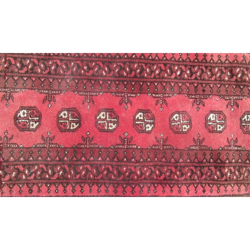 310 - C20th Caucasian red ground runner, with eight octagonal medallions surrounded by geometric three pan... 